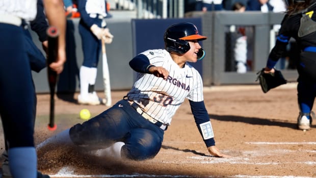 Bella Cabral slides home safe during the Virginia softball game against Delaware at Palmer Park.